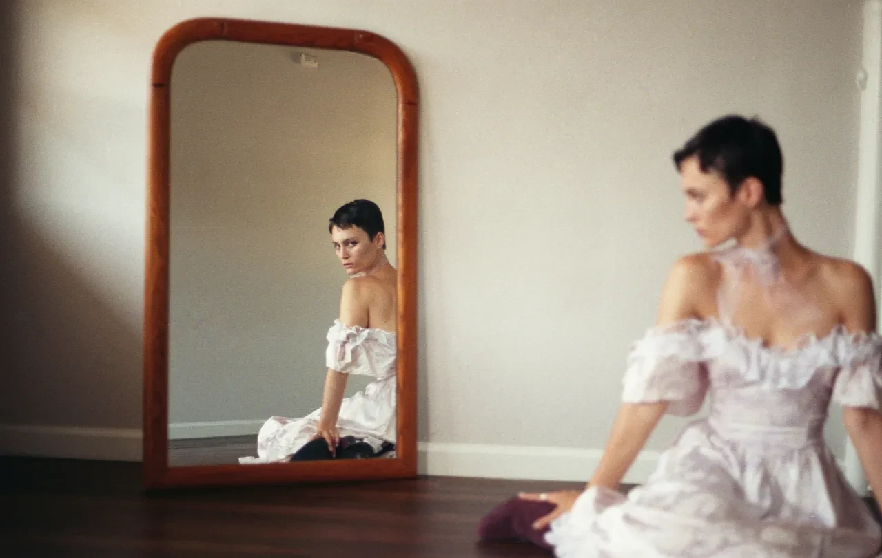 Portrait with mirror reflection, white ruffled dress