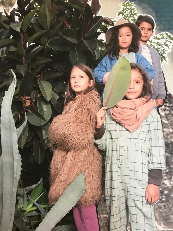 Children styled in editorial fashion with plants