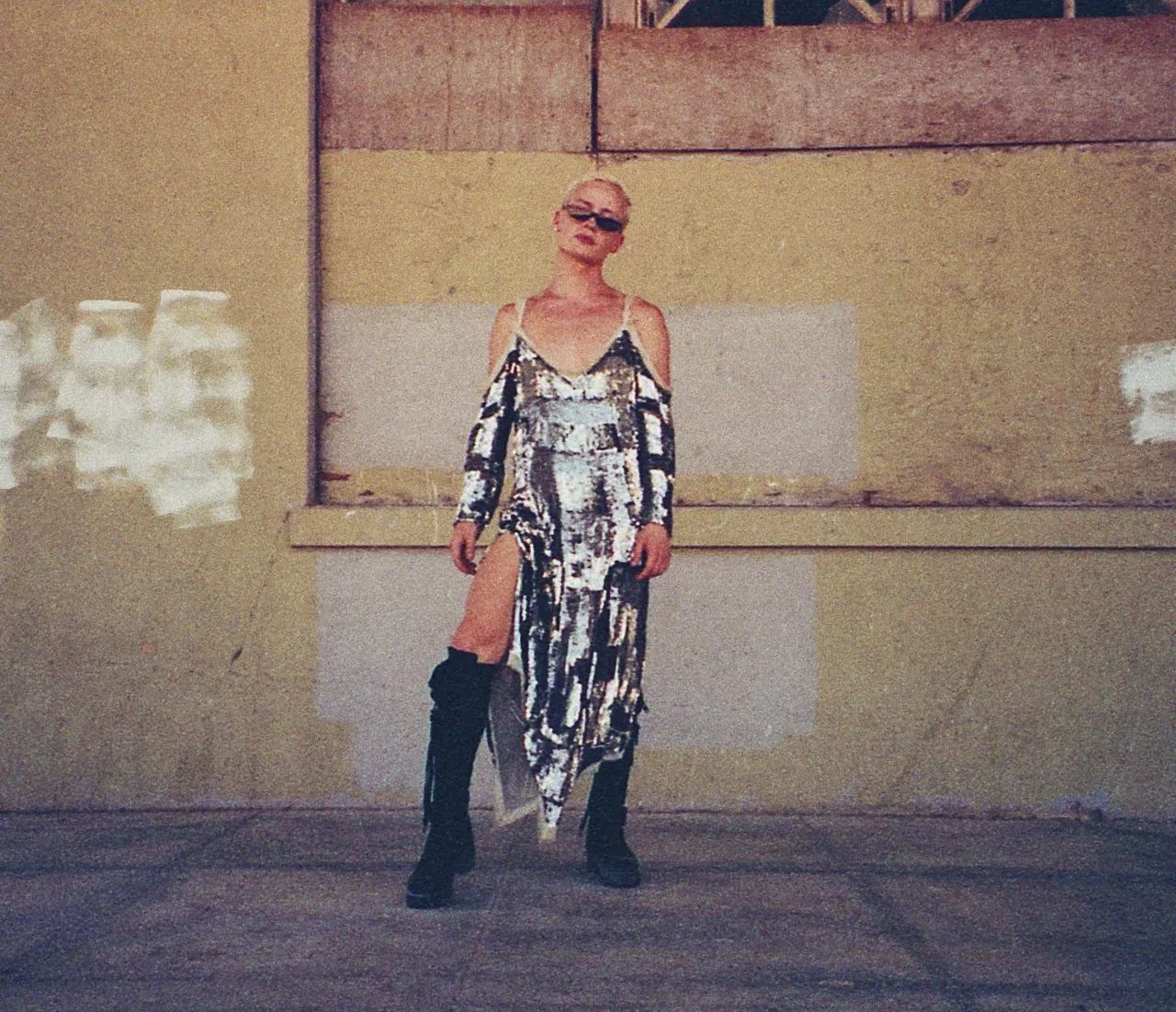 Woman in silver sequin dress, urban rooftop